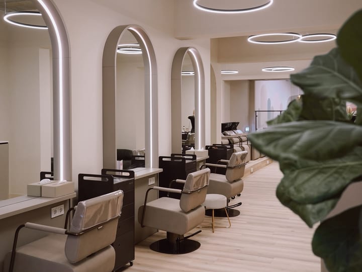 INIZIO salon interior with illuminated mirrors and styling chairs