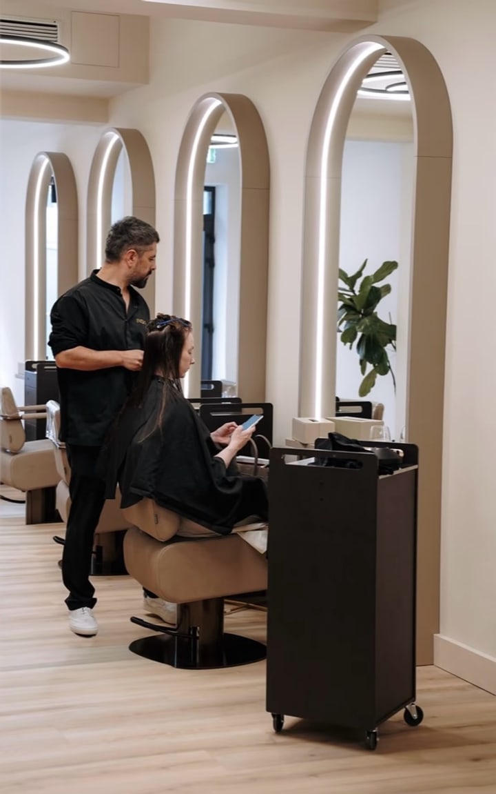 INIZIO hairstylist working with a client in the salon
