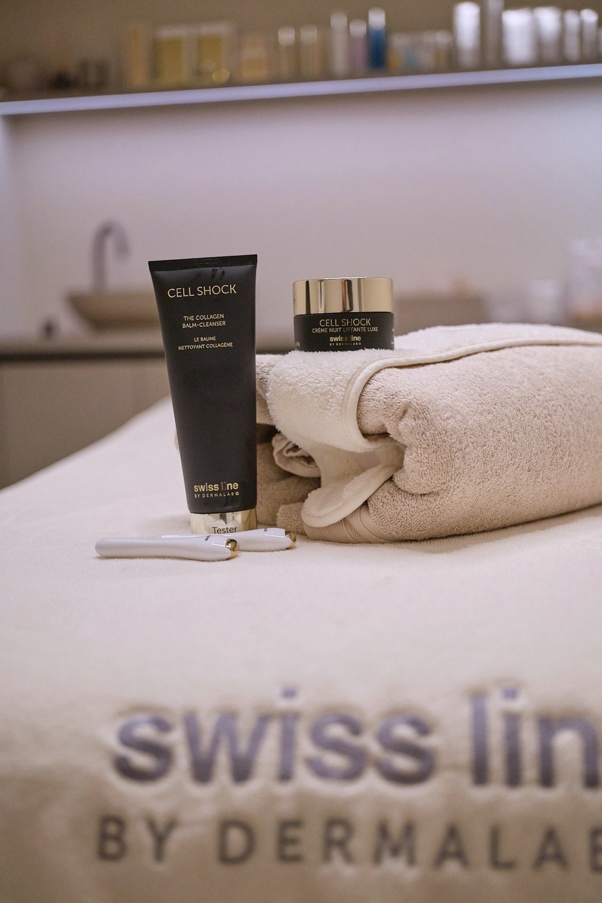 Skincare textures and refined facial-care products arranged in soft light