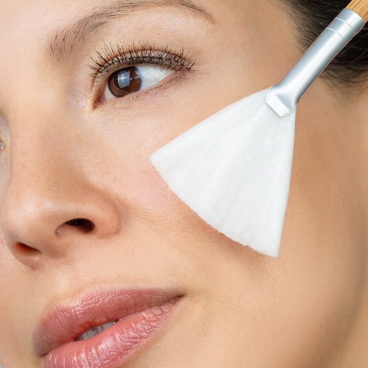 Swissline facial treatment applied with a skincare brush